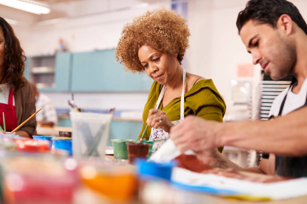 istock Group Of Mature Adults Attending Art Class In Community Centre 1145048454