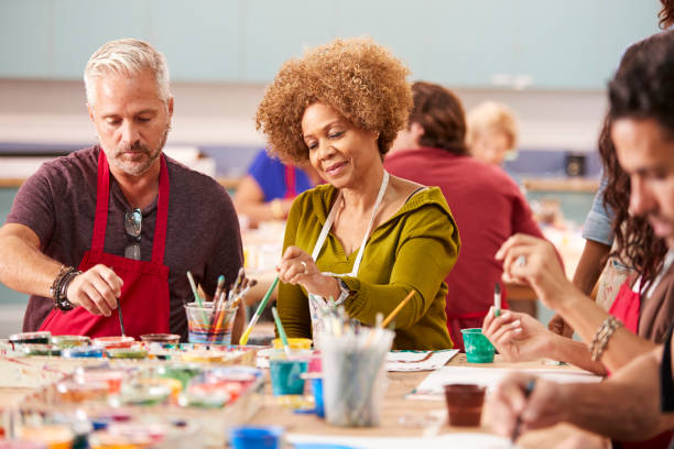 istock Group Of Mature Adults Attending Art Class In Community Centre 1145048656