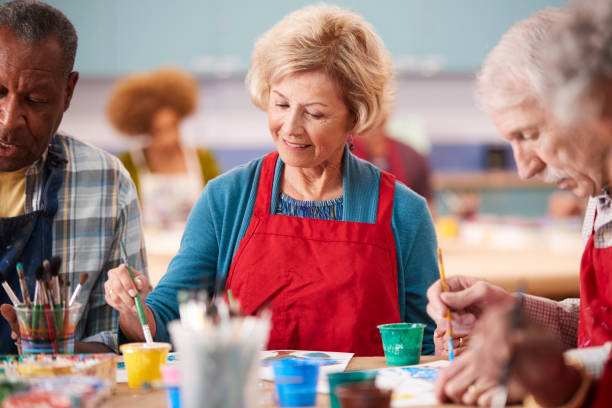 istock Retired Senior Woman Attending Art Class In Community Centre 1145048756