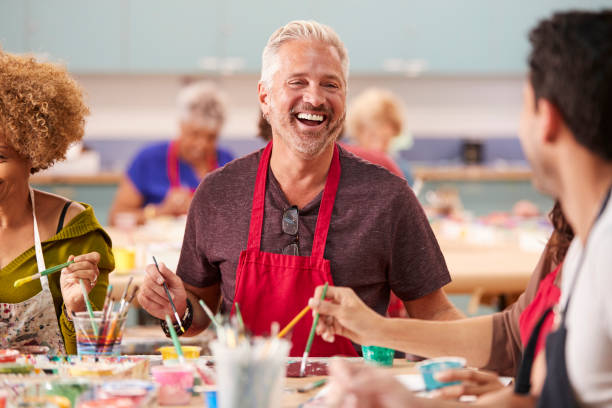 istock Group Of Mature Adults Attending Art Class In Community Centre 1145048757