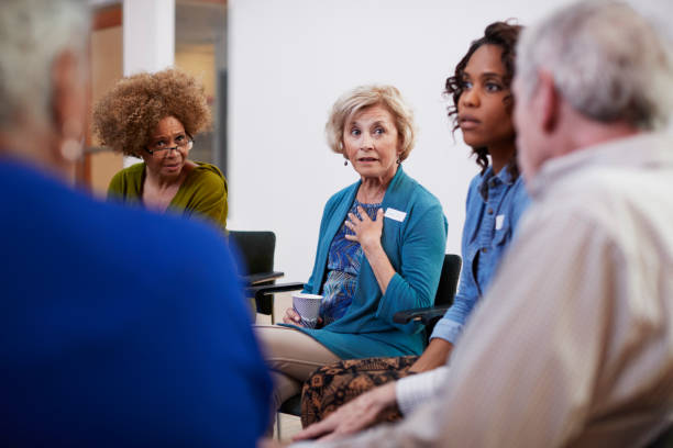 istock People Attending Self Help Therapy Group Meeting In Community Center 1145049947