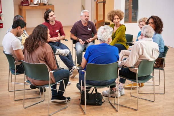 istock People Attending Self Help Therapy Group Meeting In Community Center 1145050975