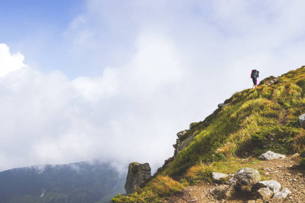 istock Traveler climbs a mountain, travel concept 1145051031
