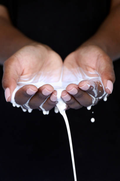 istock Black african hands holding dripping milk beauty 1145051083
