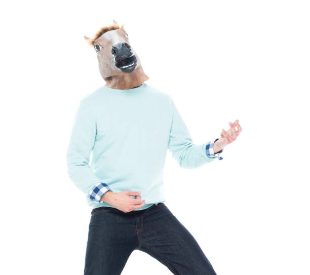 istock Man with horse mask doing air guitar 1145051268