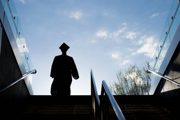 istock Silhouette of College Graduate Climbing Steps 1145052896