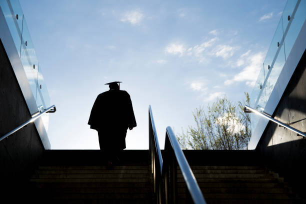University, students and man with graduation, thinking and ceremony with achievement. Education, college and people with knowledge, success and congratulations with award, celebration and learning