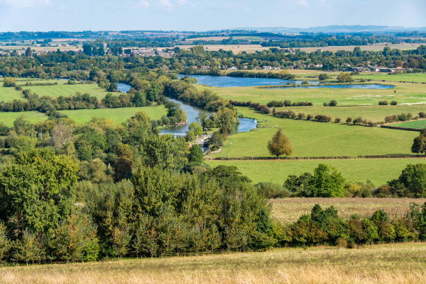 istock A sunlit rural scene with green fields and a river, seen from above. 1145053087