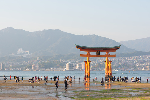 Tourist to see Floating torii gate and pray of Itsukushima Shrine at Miyajima island Hiroshima, Japan.The landmark and favorite place of Tourist
