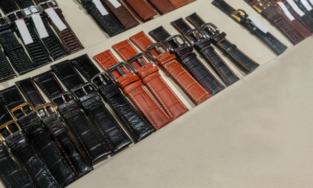Strap on a wristwatch, watch bracelet. Selective focus on red brown crocodile grain leather strap.