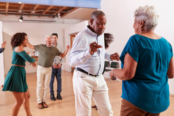 People Attending Dance Class In Community Center People Attending Dance Class In Community Center active seniors stock pictures, royalty-free photos & images