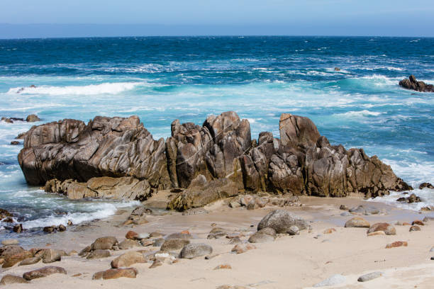 The nutrient-rich waters of the Pacific Ocean washes against the beautiful, rocky California coastline in Monterey Bay. This area is known for its spectacular natural scenery.