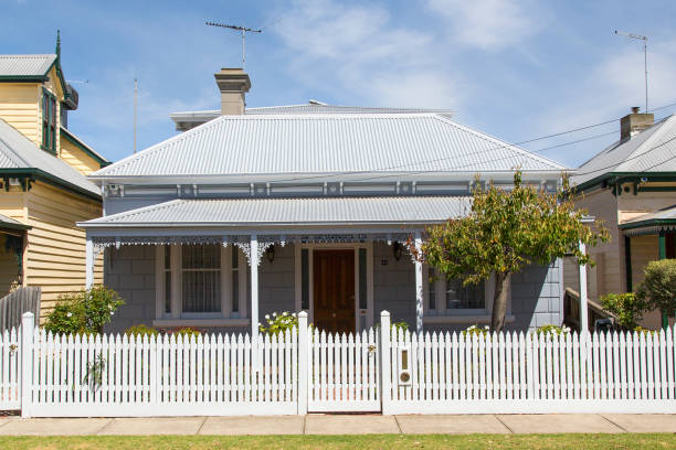 Traditional House with a white picket fence - Melbourne Williamstown, Australia: March 07, 2019: Traditionally built bungalow in the 20th century Australian style in Williamstown with a porch, ornate verandah, garden gate and white picket fence. bungalow photos stock pictures, royalty-free photos & images