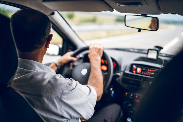 istock Senior man driving car 1145058500