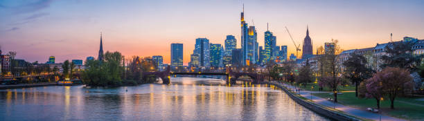 istock Frankfurt financial district skyscrapers glittering River Main panorama sunset Germany 1145060358