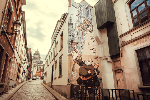 Brussels, Belgium: Old street with houses and artworks in comic style in historical city on April 3, 2018. More than 1,200,000 people lives in Brussels