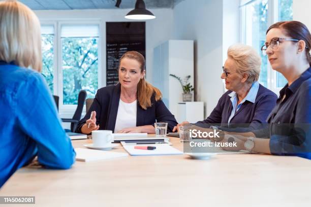 Professional Planning With Colleagues In Meeting Stock Photo - Download Image Now - 35-39 Years, 40-44 Years, 70-79 Years