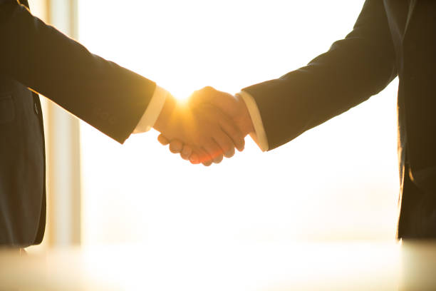 istock The men handshake on the sunny background 1145066072