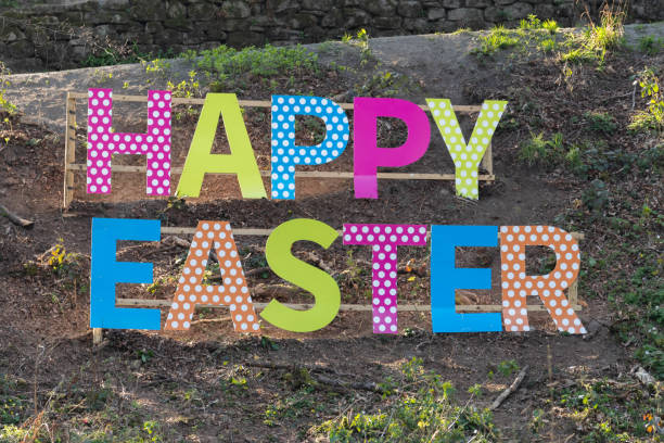 istock Large Happy Easter Sign on a Grassy Banking 1145066303