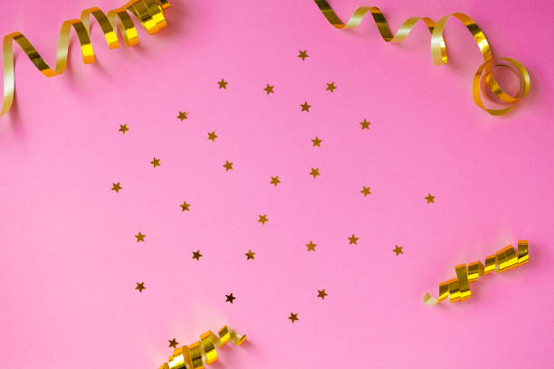 istock Golden decorations and sparkles on pink background 1145066714
