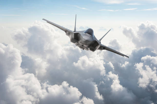 Fighter Jet flying over the clouds Fighter Jet flying over the clouds military airplane stock pictures, royalty-free photos & images