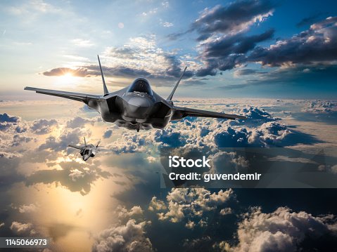 istock F-35 Fighter Jets flying over the clouds at sunset 1145066973