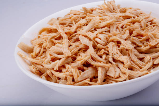 istock Shredded chicken breast in white dish with spices 1145067843