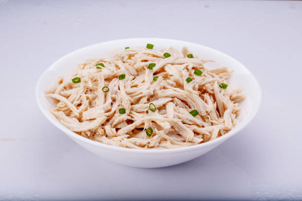 istock Shredded chicken breast in white dish with spices 1145067851