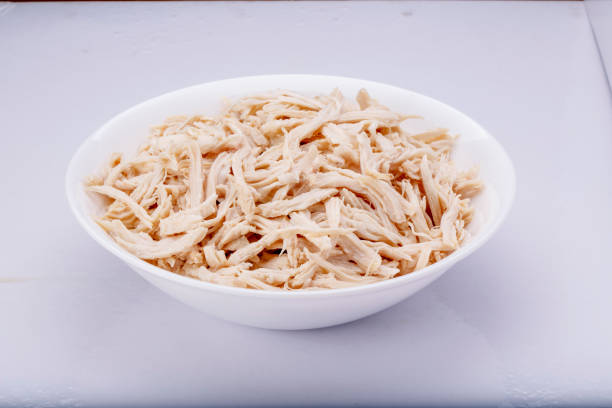 istock Shredded chicken breast in white dish with spices 1145067874