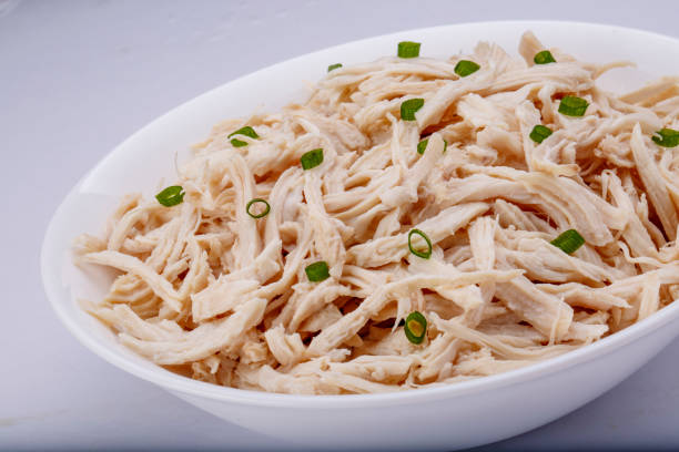 istock Shredded chicken breast in white dish with spices 1145067875