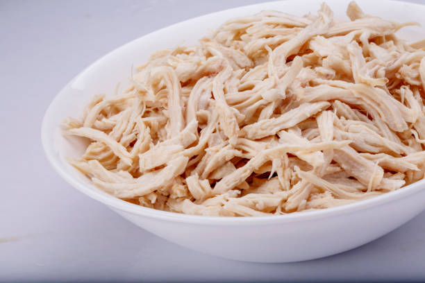 istock Shredded chicken breast in white dish with spices 1145067905