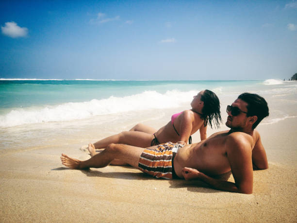 istock Couple enjoying on a sandy ocean tropical beach. 1145068075