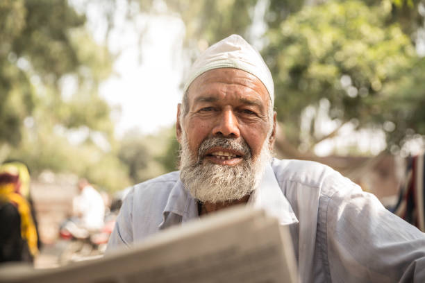 istock Senior Indian Man Reading Newspaper Outdoors 1145068521