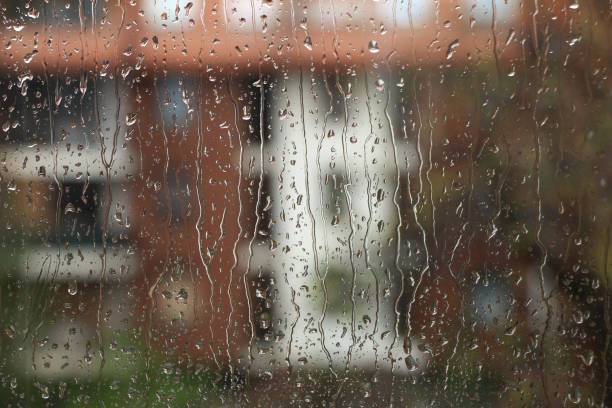 istock Spring rainy day , rain drops on glass 1145069153