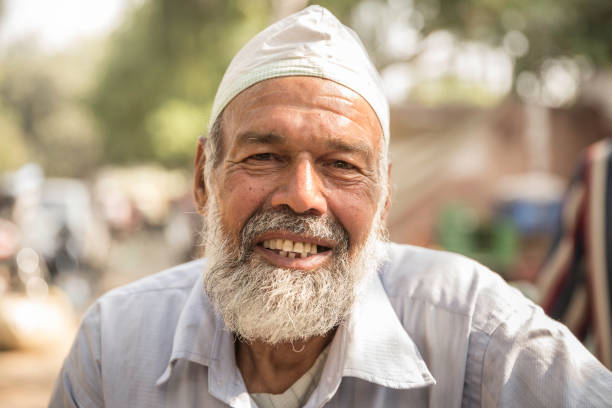 Gujarat.,India-February 7, 2017：Elderly Rabari tribesman with big red turban sit on road. Rabari or Rewari are an Indian community in the state of Gujarat.