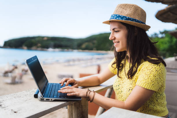 using laptop in beach café - on beach laptop working imagens e fotografias de stock