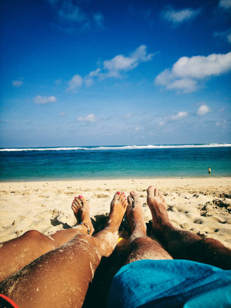 istock Couple lying and enjoying on a sandy tropical beach. 1145070105