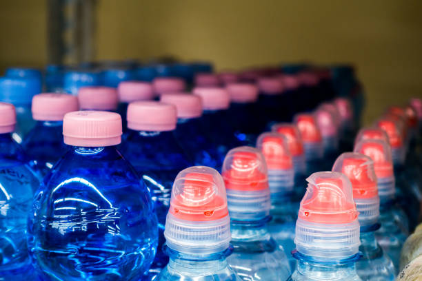 istock Lid plastic water bottle in the market. multi-colored plastic bottle caps 1145070779