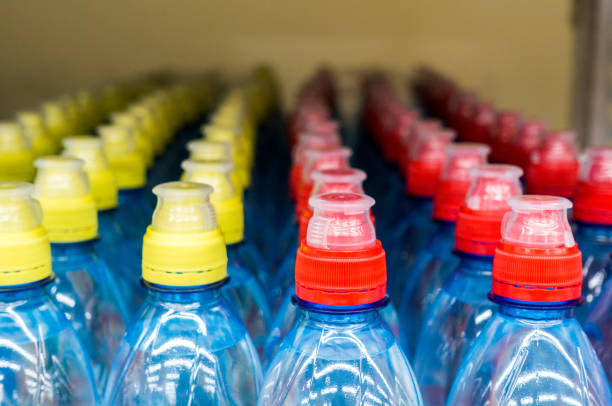 istock Lid plastic water bottle in the market. multi-colored plastic bottle caps 1145070784