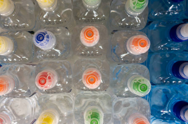 istock Lid plastic water bottle in the market. multi-colored plastic bottle caps 1145070798