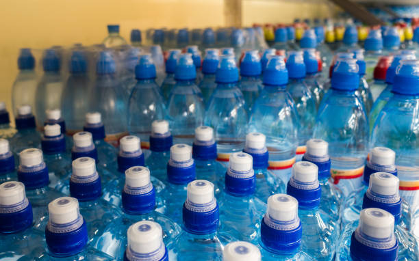 istock Lid plastic water bottle in the market. multi-colored plastic bottle caps 1145070871