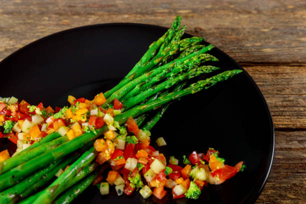 istock Portion asparagus with a salad of arugula and tomato crushed 1145073978