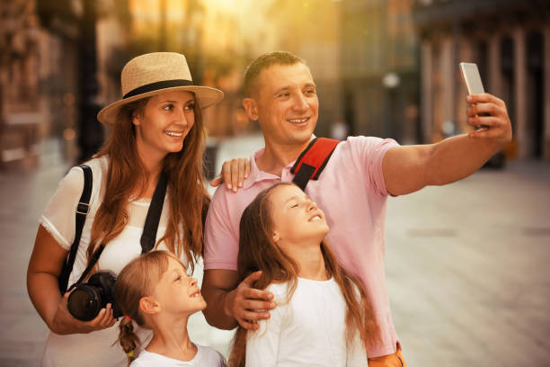 istock Joyful parents with two kids taking selfie 1145076746