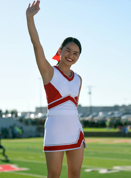 istock Attractive young cheerleader performing at a high school athletic event 1145078300