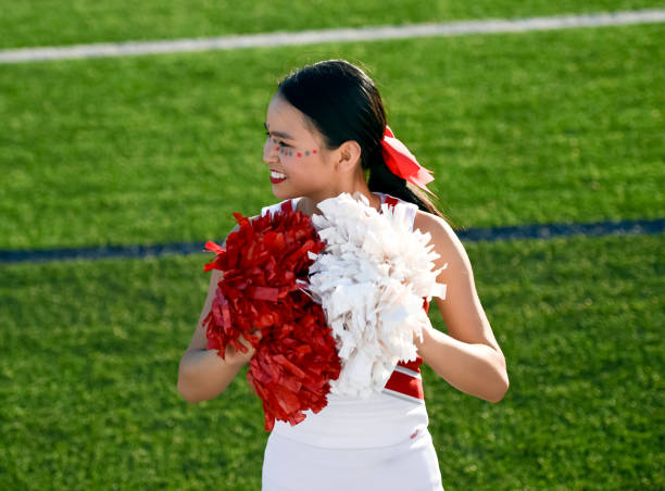 istock Attractive young cheerleader performing at a high school athletic event 1145078335