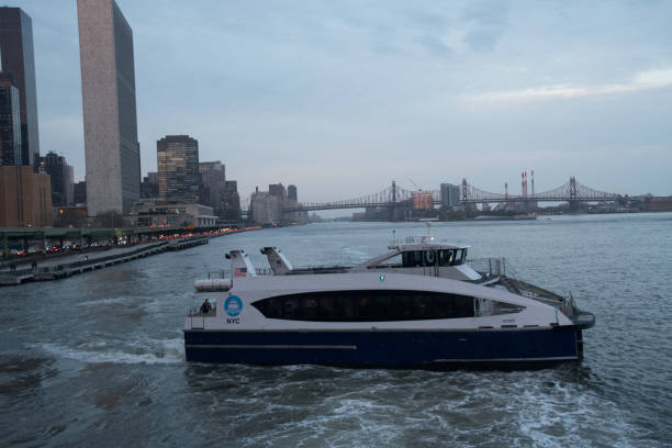 New York City, NY, USA - April 10, 2019: NYC Ferries on the East River at Sunset taking busy commuters home after another work day.  A great alternative to the Subway.