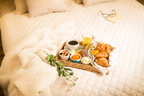 istock Continental breakfast on bed in elegant bedroom interior 1145080284