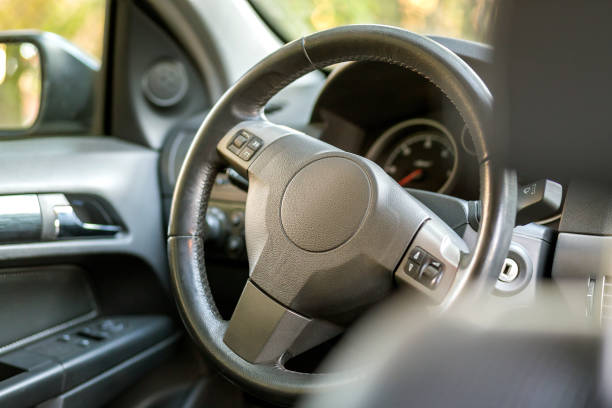 istock Modern expensive car black luxurious interior. Steering wheel, dashboard, windshield and mirror. Transportation, design, modern technology concept. 1145081469