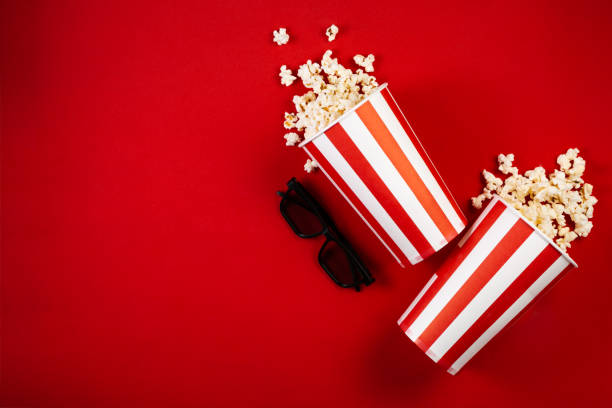 istock Movie night concept - pop corn, glasses, bright red background 1145081515