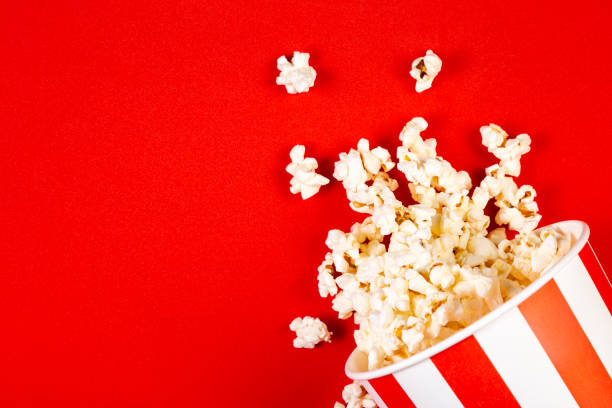 istock Movie night concept - pop corn, glasses, bright red background 1145081793